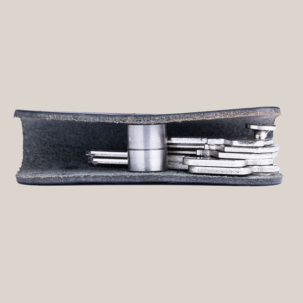 Side profile of a premium leather black key organizer with magnetic buckle